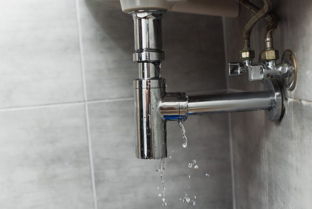 leaking plumbing pipe in a gray tiled bathroom 2026 03 12 23 57 24 utc Large