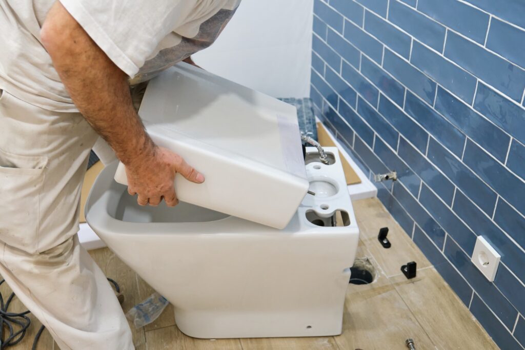 plumber installing a toilet in a modern bathroom 2026 03 24 00 32 25 utc Large