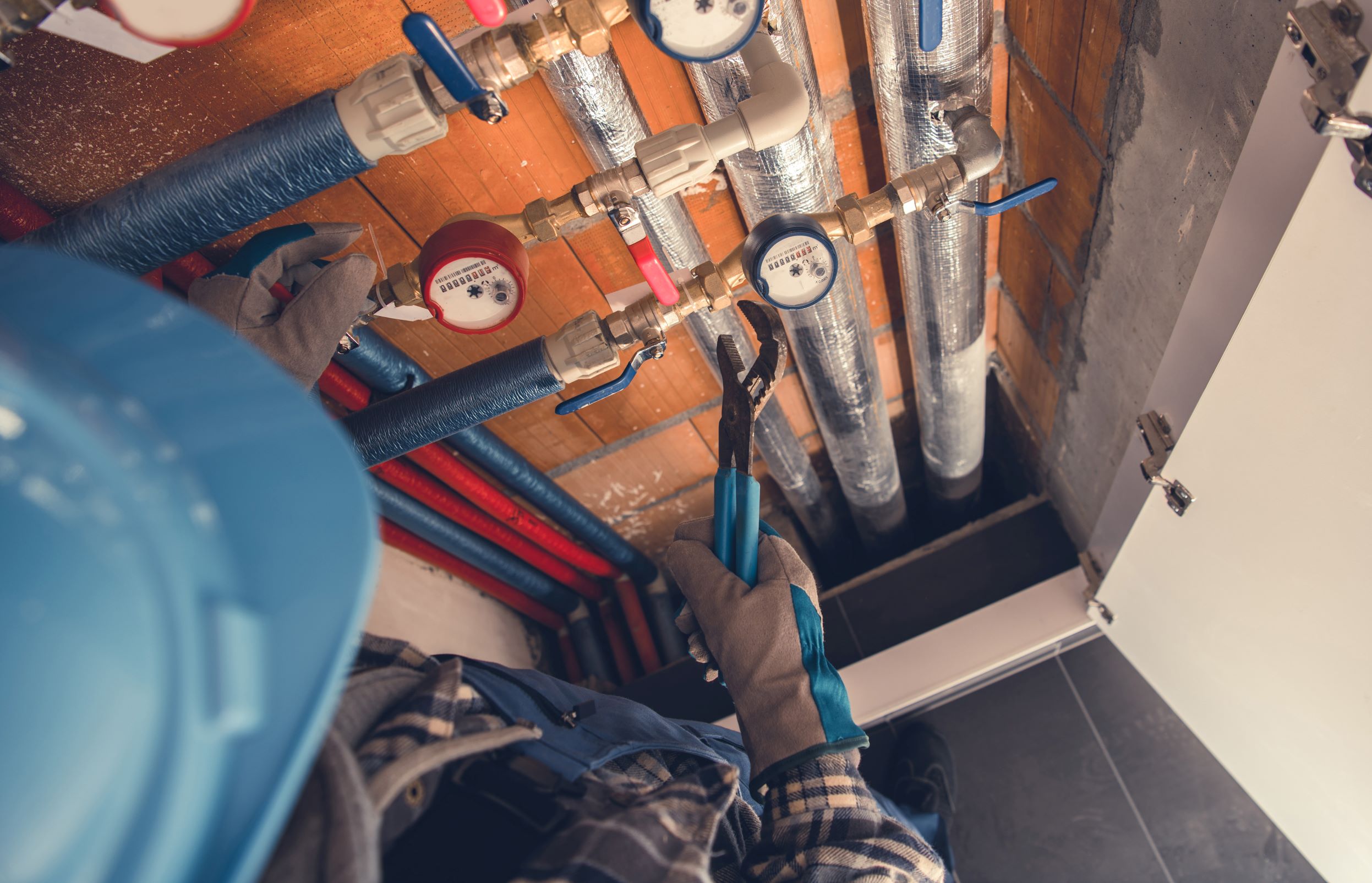 plumber repairs pipes under a house with tools 2026 03 24 07 12 48 utc1