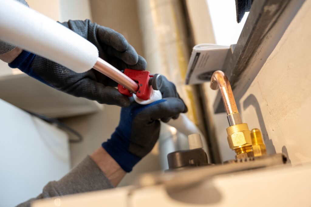 plumbing professional fitting a pipe with gloves 2026 03 25 02 44 43 utc