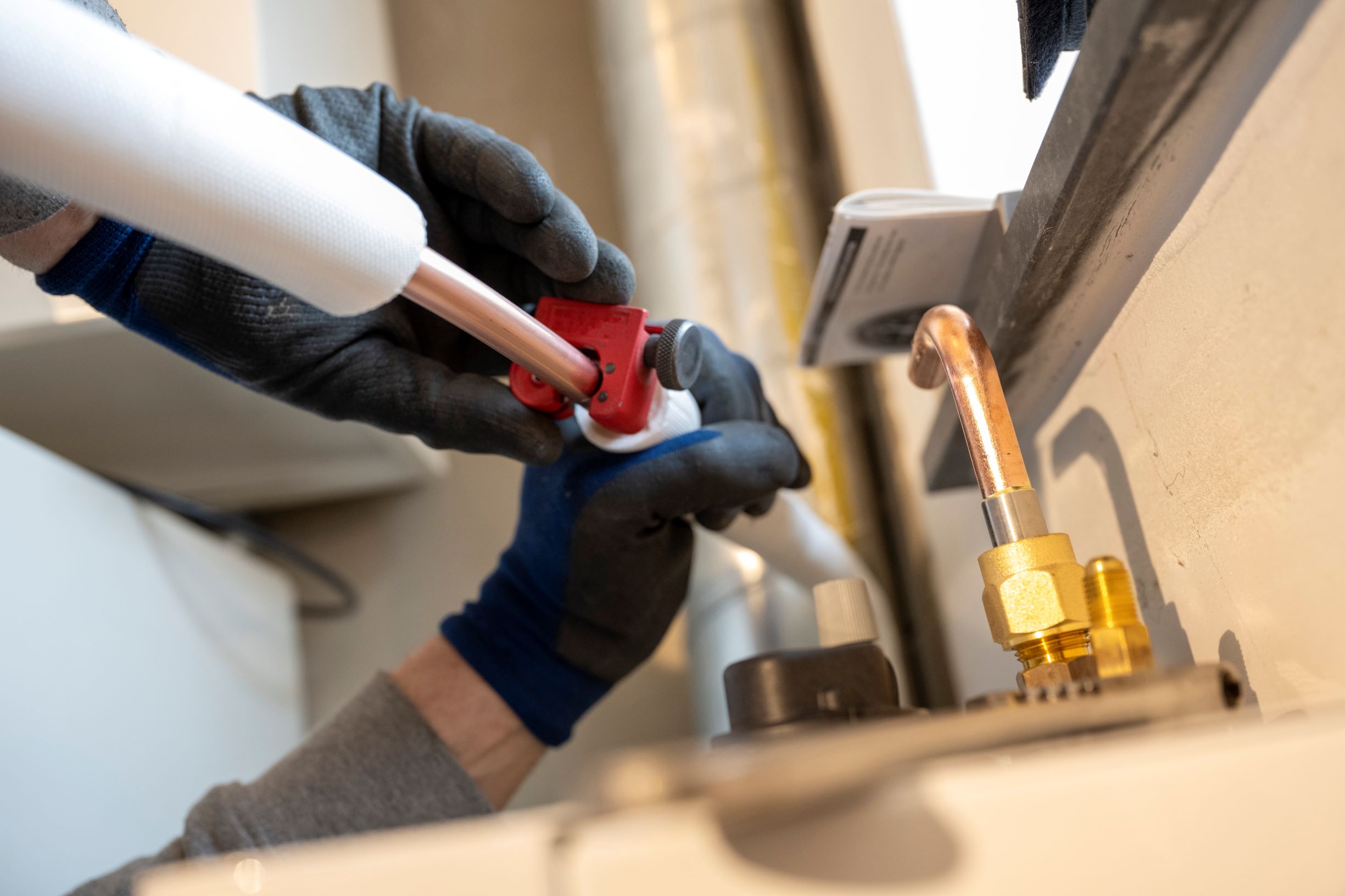 plumbing professional fitting a pipe with gloves 2026 03 25 02 44 43 utc