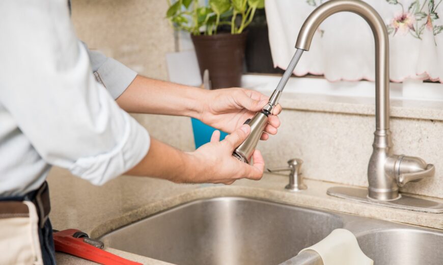 repairman fixing the kitchen faucet at home 2026 01 09 11 44 38 utc Large