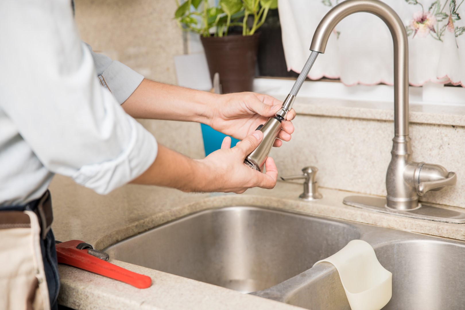 repairman fixing the kitchen faucet at home 2026 01 09 11 44 38 utc Large